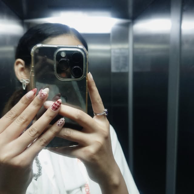 Long almond nails in red check and dots